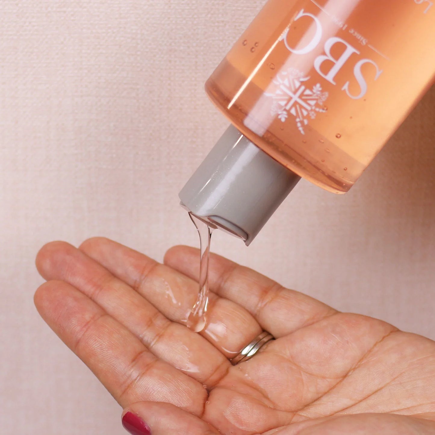 Lotus Flower Intimate Wash 300ml lifestyle shot with hand swatch