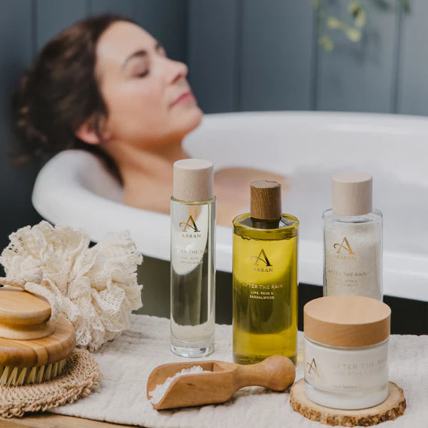 After the Rain Bath & Shower Gel - 300ml lifestyle shot of collection of products and woman bathing