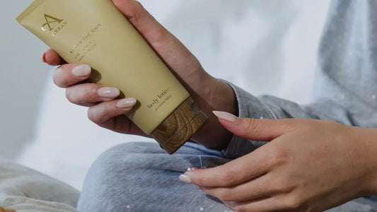 Woman opening Arran Aromatics After the Rain Body lotion