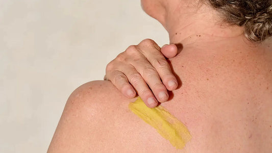 Woman using Balmonds Skin Salvation on back