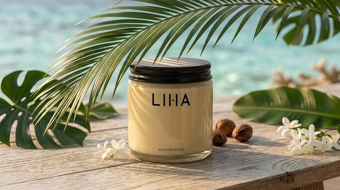 LIHA Beauty Shea Butter Gold on a tropical beach with palm leaves