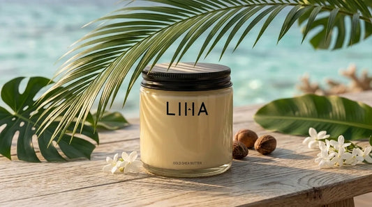 LIHA Beauty Shea Butter Gold on a tropical beach with palm leaves