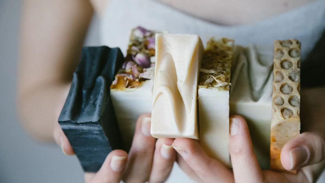 Woman clutching multiple hand made soaps