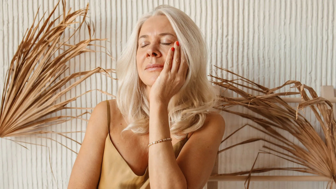 Woman enjoying the benefits of skincare and makeup in a boho setting