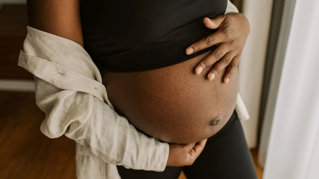 Woman holding pregnant belly avoiding certain skincare