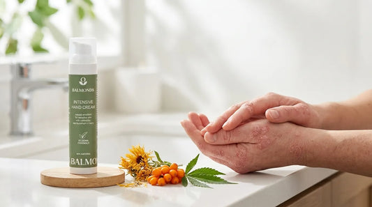 Woman with psoriasis at the kitchen sink with Balmonds Intensive Hand Cream