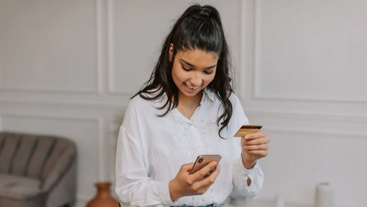 Woman holding credit card for buying natural skincare