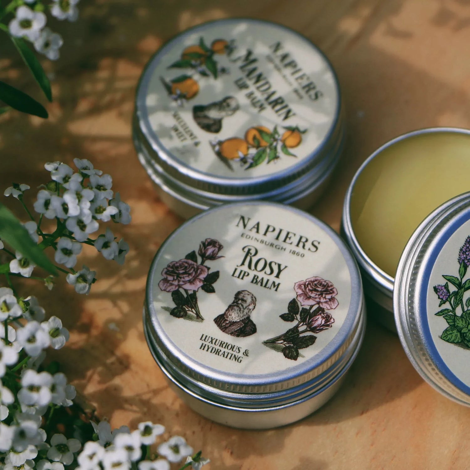 Napiers The Herbalists Mandarin Lip Balm and Lip Tint lifestyle shot with flowers
