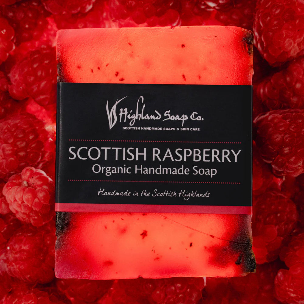 Bar of Scottish Raspberry soap from Highland Soap Company surrounded by raspberries