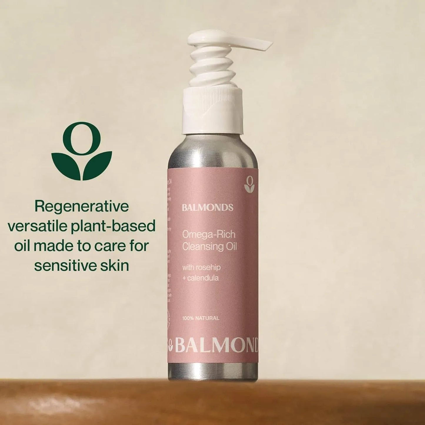 Balmonds Omega Rich Cleansing Oil bottle with pink label on a beige background