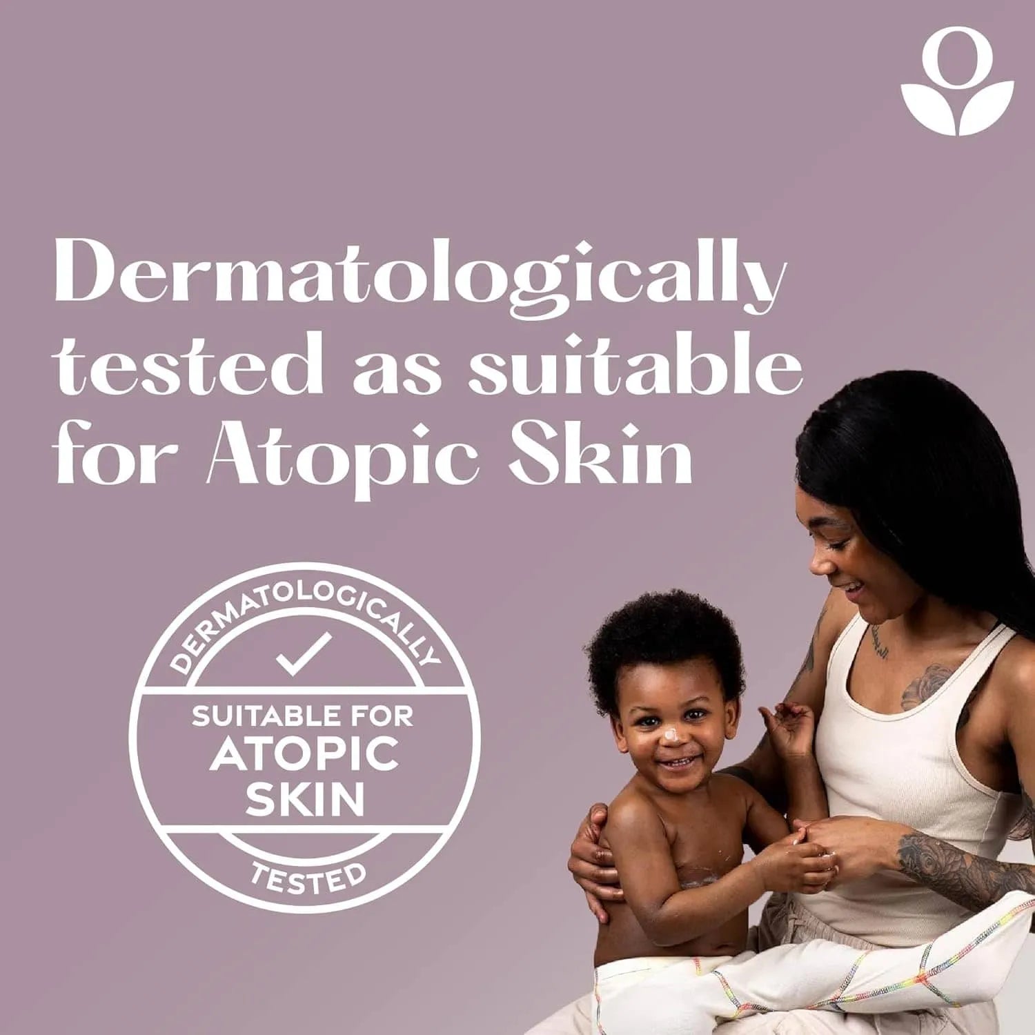 Balmonds Hydrating Body Oil - 200ml model shot with woman holding a child with a label indicating dermatological testing for atopic skin on a purple background