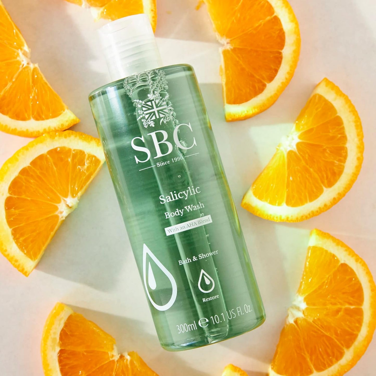 SBC Skincare Salicylic Body Wash lifestyle shot with orange slices