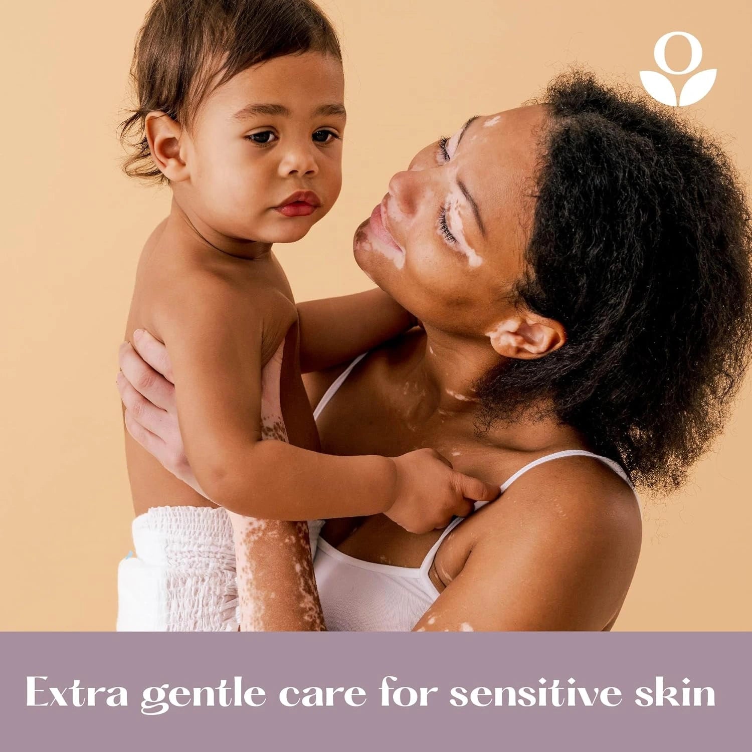 Balmonds Body, Hand & Hair Wash - 200ml model shot of woman holding a child with a product logo and text about sensitive skin care on a beige background