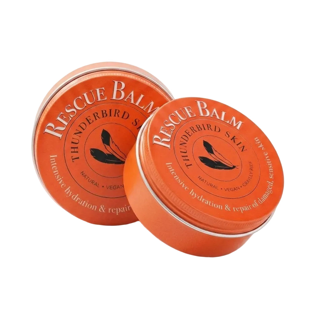 Two round orange metal tins of Rescue Balm Thunderbird Skin intensive hydration and repair cream, shown on a clean white background.