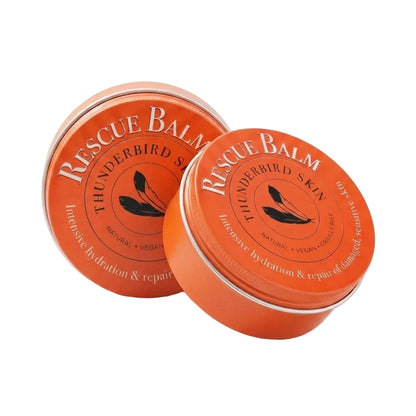 Two round orange metal tins of Rescue Balm Thunderbird Skin intensive hydration and repair cream, shown on a clean white background.