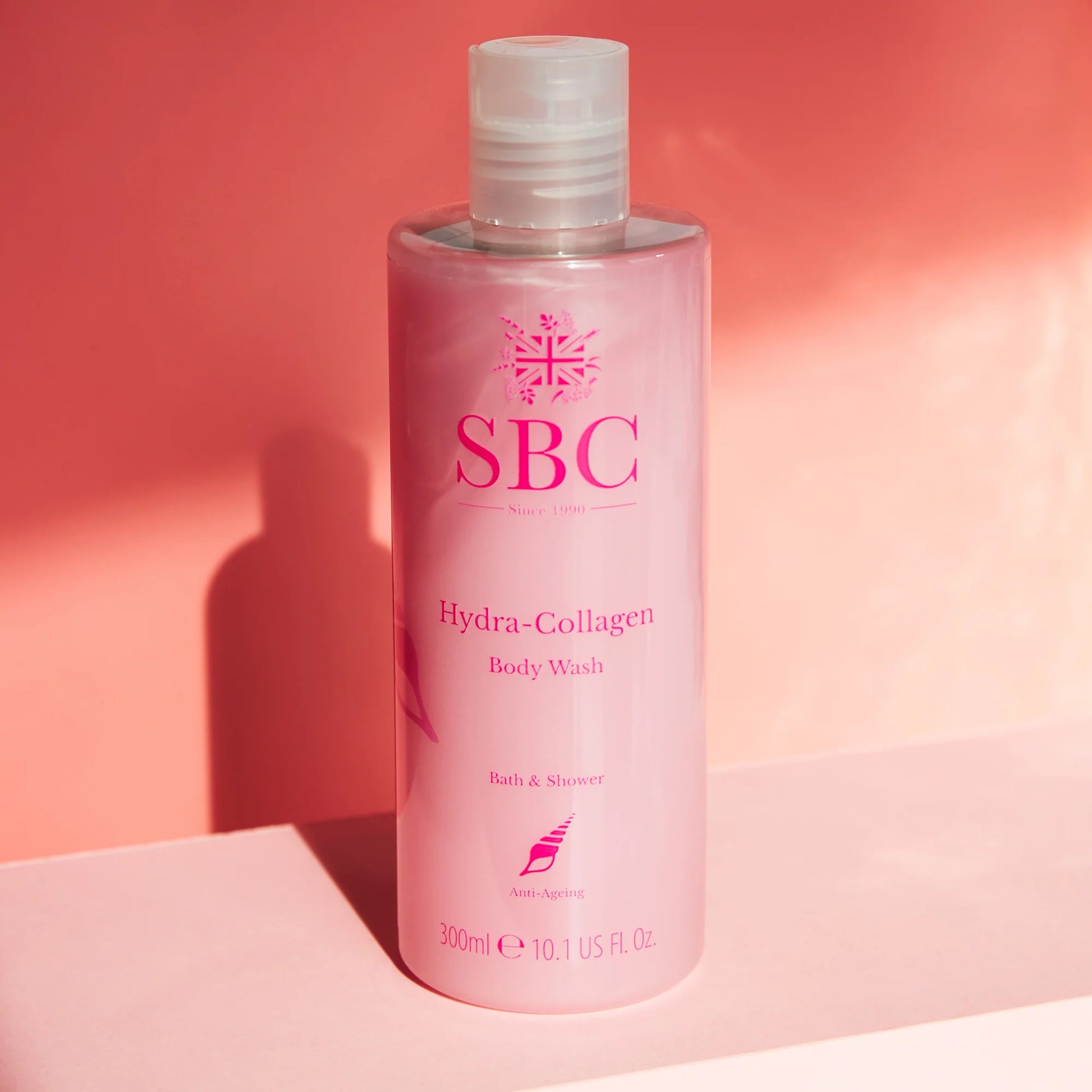 Hydra-Collagen Body Wash 300ml lifestyle shot with pink background