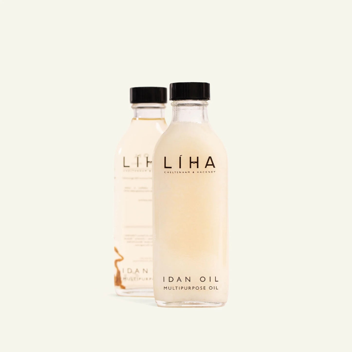 Two bottles of IDAN LIHA oil on a white background