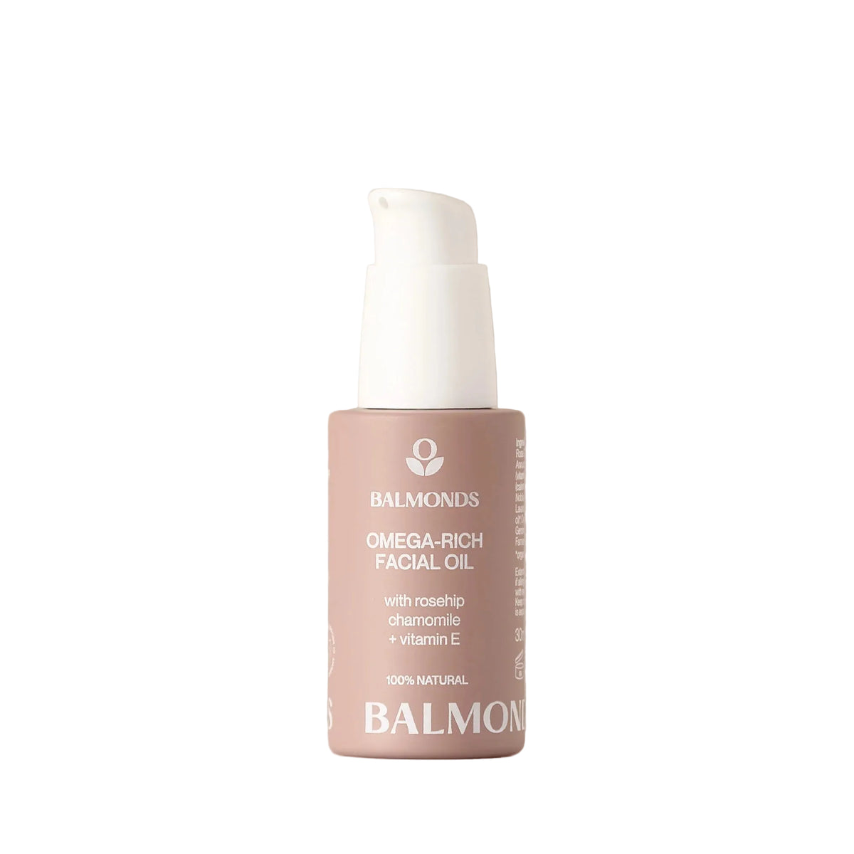 A bottle of Balmonds Omega-Rich Facial Oil with a white pump dispenser and a dusty pink label, set against a soft beige background.