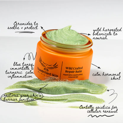 Orange jar of 'Thunderbird Skin' Wild Crafted Repair Balm with green cream on a white background