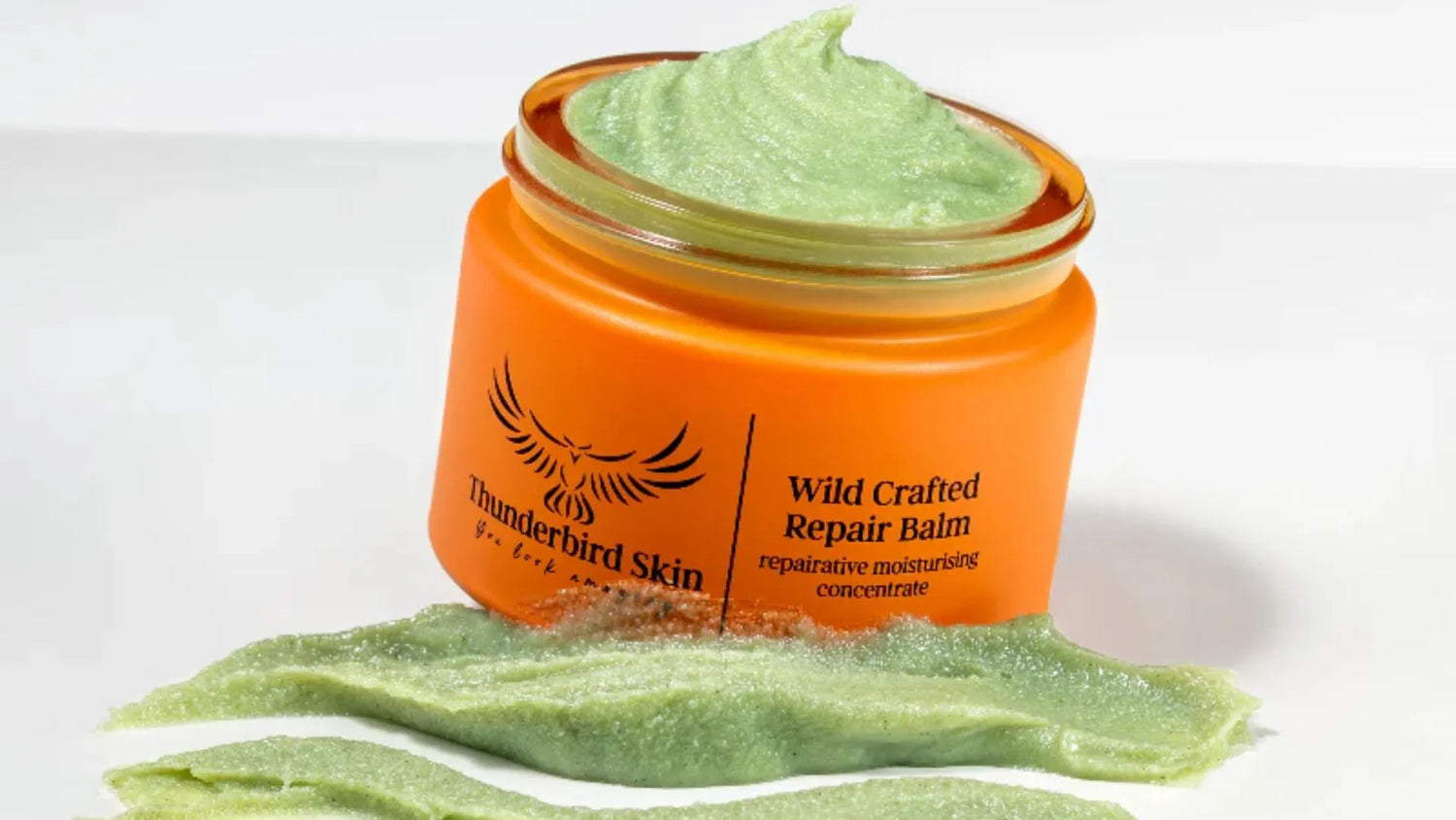 Wild Crafted Repair Balm with green swatch and white background