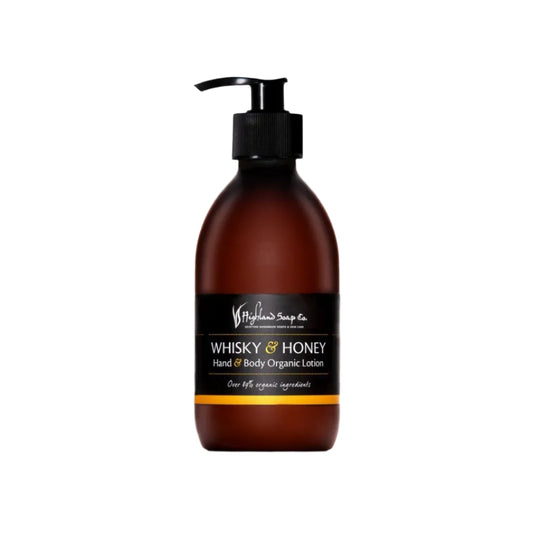 Brown bottle of Whisky & Honey hand and body organic lotion with pump on a white background
