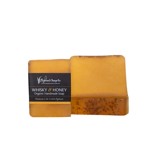 Two bars of 'Whisky & Honey' organic handmade soap from Highland Soap Company on a white background