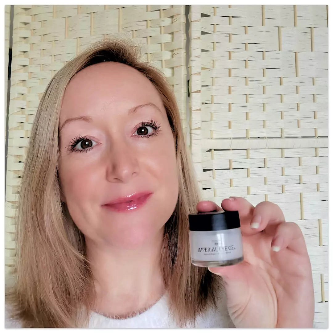 Woman holding a jar of 'Imperial Eye Gel' against a woven beige background